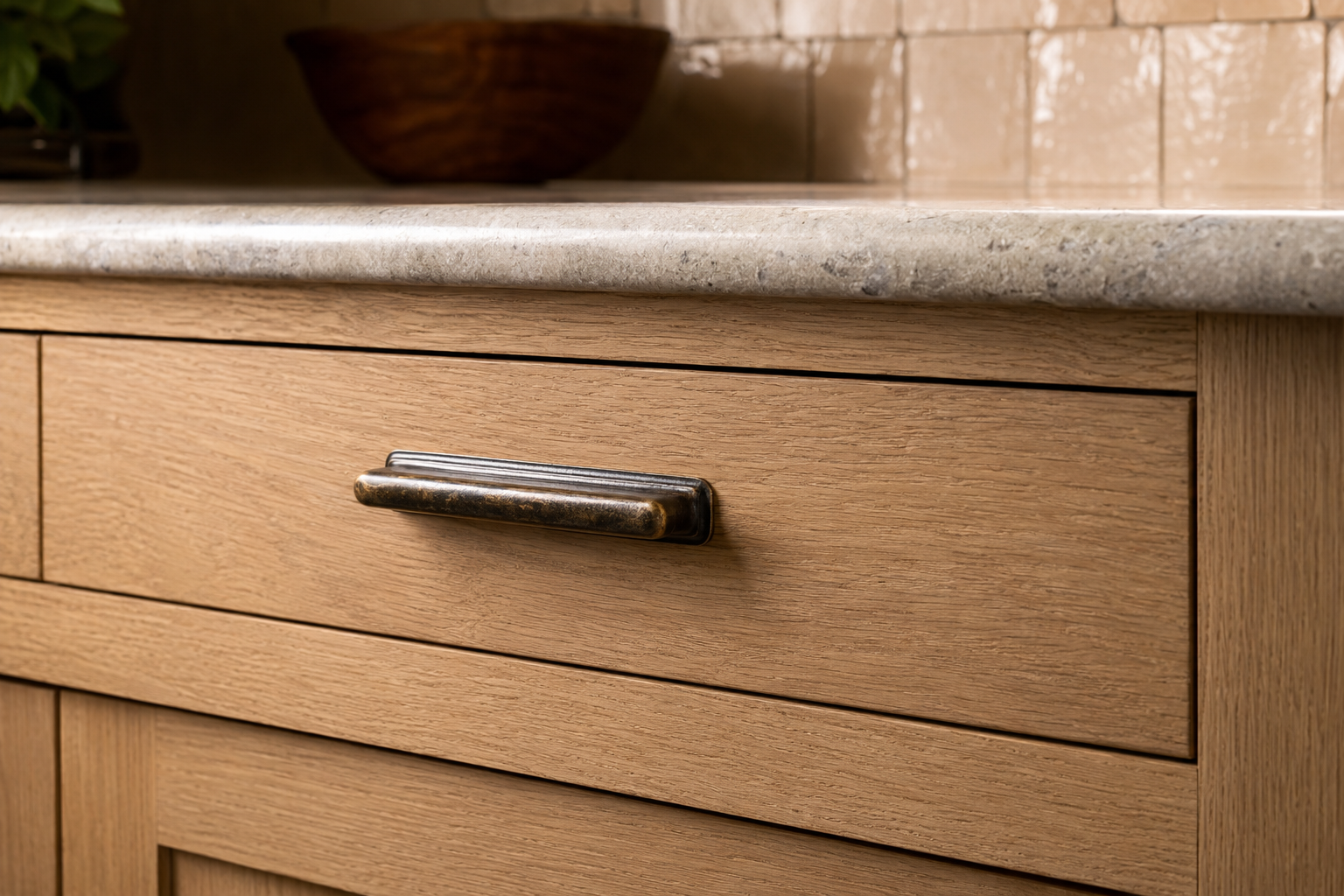 Oak cabinetry and bronze hardware detail